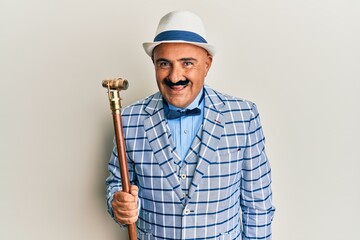 Mature middle east man with mustache wearing vintage and elegant fashion style looking positive and happy standing and smiling with a confident smile showing teeth