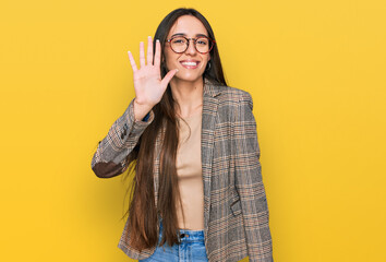 Young hispanic girl wearing business clothes and glasses showing and pointing up with fingers...