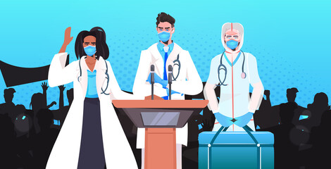 doctors in masks giving speech at tribune with microphone fight against coronavirus medical conference