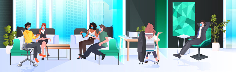 businesspeople in masks working and talking together in coworking center coronavirus pandemic teamwork concept