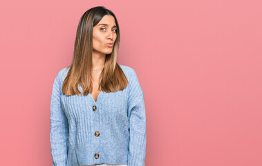 Obraz premium Young woman wearing casual clothes looking at the camera blowing a kiss on air being lovely and sexy. love expression.