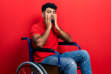 Fototapeta na wymiar Arab man with beard sitting on wheelchair tired hands covering face, depression and sadness, upset and irritated for problem