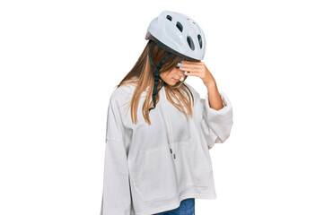 Teenager caucasian girl wearing bike helmet tired rubbing nose and eyes feeling fatigue and headache. stress and frustration concept.