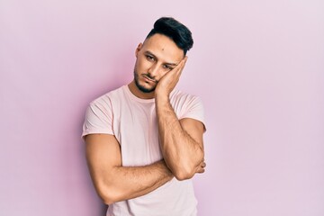 Young arab man wearing casual clothes thinking looking tired and bored with depression problems with crossed arms.
