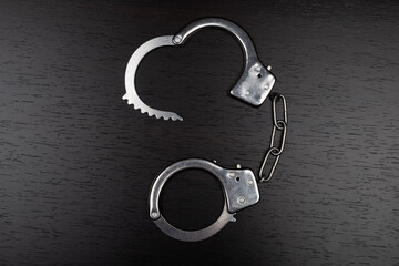 handcuffs on table, concept of arrest for violation.