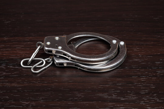 handcuffs on a dark background closeup,crime arrest.