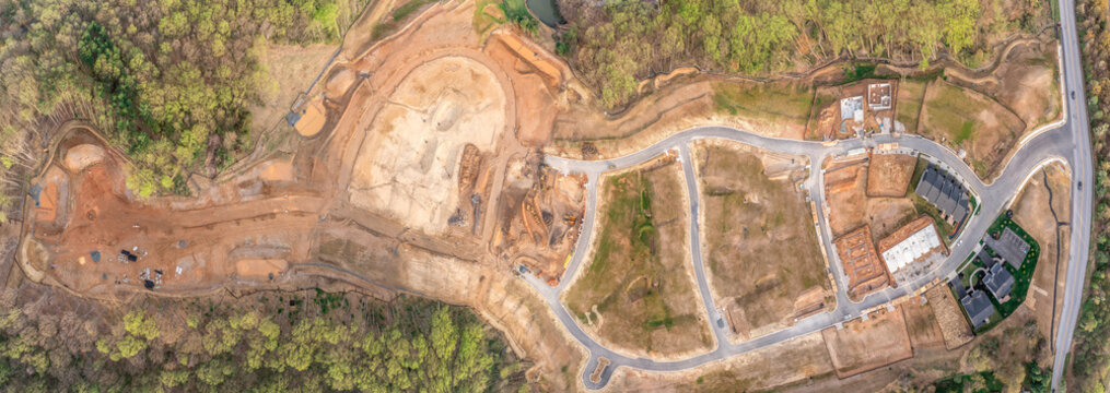 Aerial View Of New Neighborhood Construction Site For American Real Estate Development With Single Family Homes And Townhouses With Good School District Roads Still Being Built