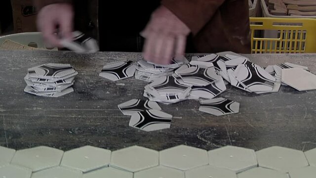 Worker Counting Synthetic Leather Hexagons of Footballs at a Soccer Ball Factory. Close Up.