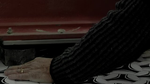 Old Worker Hand cutting Pieces of Synthetic Hexagons and Pentagons at a Football Ball Factory. Close Up.