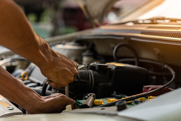 Mechanic in work uniforms, car service Repair and maintenance of broken cars on the side of the road.