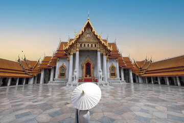Marble temple Bangkok with a beautiful lady in front holding an umbrella