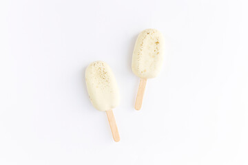 Flat lay with white cookie ice creams on a stick on white background