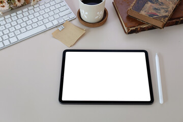 Digital tablet with blank screen on white office desk.