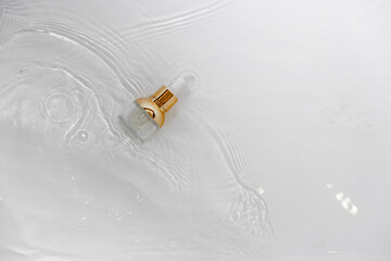 Transparent golden bottle with pipette and hylauronic acid. Top horizontal view copyspace