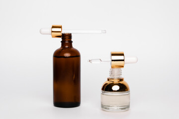 Amber glass bottles with pipette. Transparent hyaluronic gel and oil skin care concept. Top horizontal view copyspace