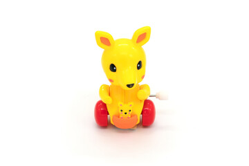 Plastic yellow toy kangaroo isolated in white background.