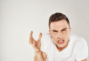 Naklejka premium man gesturing with his hands indignant look light background cropped view Copy Space