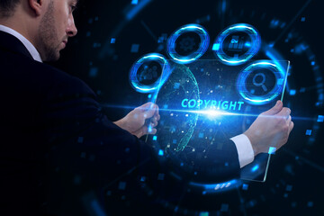 Business, Technology, Internet and network concept. Young businessman working on a virtual screen of the future and sees the inscription: Copyright