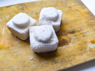 three pieces of salt on a cutting board. block shape. sea salt.