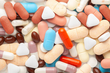 Close up of medicinal or herbal multi-color tablet, capsule, and pill on the full-frame background. Top view,