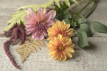 Orange dahlia on a wooden background