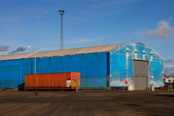 Obraz premium Halmstad, Sweden, A warehouse building in the harbour and orange container.
