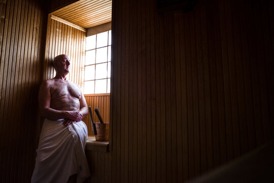 Halmstad, Sweden, A middle aged man sits alone in a sauna.
