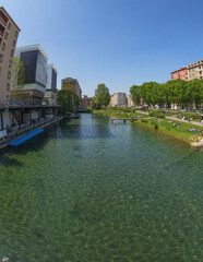 Darsena at Porta Ticinese,the dock, the ideal place to get a tan in a beautiful spring day.Milan, Lombardy, Italy.