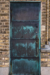 Halmstad, Sweden, A weathered green brass door on the facade of a church