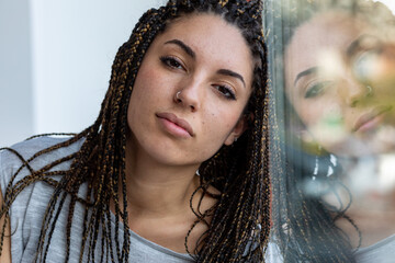 Young woman with dreadlocks and nose piercing