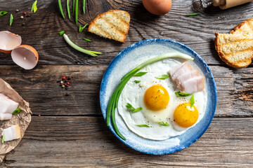 Traditional Ukrainian or belorussian food. Breakfast, lunch bacon, lard fried eggs and toast on old wooden table. banner, catering menu recipe place for text, top view