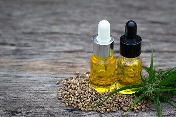 Hemp oil and hemp seeds on a wooden table, Medical marijuana products including cannabis leaf, cbd and hash oil, alternative remedy or medication,medicine concept.