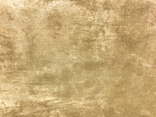 Texture decorative light beige plaster imitating old peeling wall. Obsolete cracked golden stone background with pattern