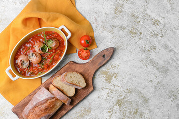 Baking dish with tasty snails on light background