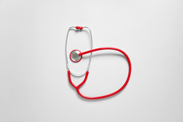 Modern stethoscope on light background
