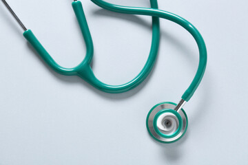 Modern stethoscope on light background, closeup