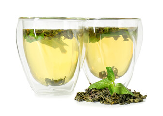 Glass cups of green tea on white background