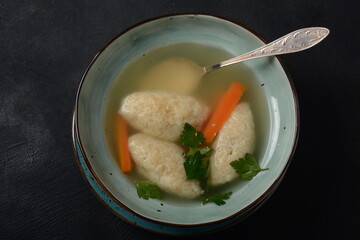 Griessnockerlsuppe. Clear Soup with Semolina Dumplings in a bowl. German food. Bavarian cuisine.