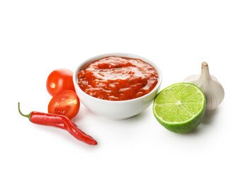 Bowl of tasty salsa sauce and ingredients on white background