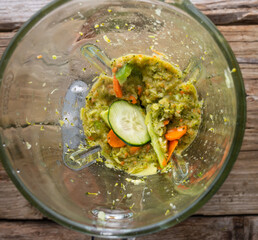 Vegetables and in a blender. Top view. Green fresh smoothie blended in a blender. Healthy food...