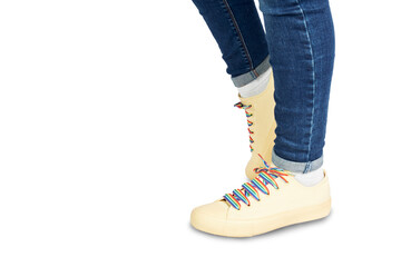 Woman feet with sneakers with laces with rainbow LGBT flag