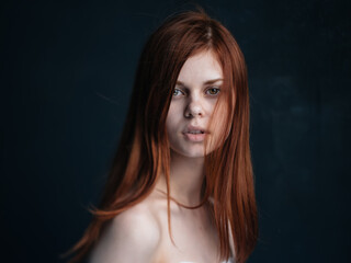 Sexy women red hair bared shoulders dark background model