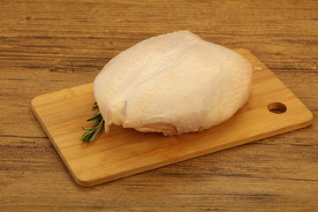 Raw whole chicken breast with skin