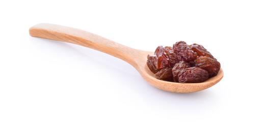 Dried raisins in spoon on white background.