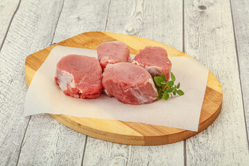 Raw pork medallion served rosemary