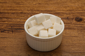 Refined white sugar cubs in the bowl