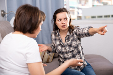 Two unhappy woman having conflict at home. High quality photo