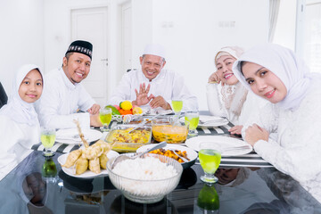 Three generation Muslim family smile in dining table