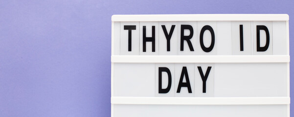 inscription international thyroid day on purple background. copy space. banner