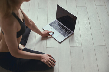 Fototapeta premium Caucasian beautiful woman is doing sports at cozy apartment